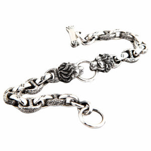 Handcrafted silver lion chain bracelet angled view highlighting textured links and lion head details