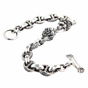 Men's sterling silver lion bracelet in S-curve position showing T-bar toggle clasp and chain texture