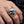Sterling silver mafia skull ring with garnet and clear cz worn on hand for scale