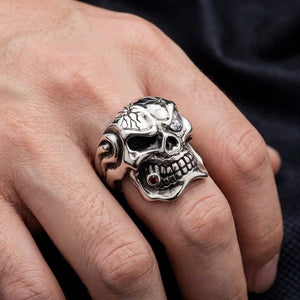 Sterling silver mafia skull ring with garnet and clear cz worn on hand for scale