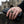 Sterling silver medieval shield ring with gold-plated cross worn beside black riding gloves