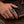 Sterling silver mystic quartz heraldic ring worn on a natural hand resting on a leather journal