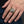 Rasta Lion Cannabis Leaf Sterling Silver Ring, worn on one middle finger in a natural hand close-up