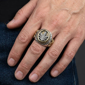 Rasta Lion Cannabis Leaf Sterling Silver Ring, worn on one middle finger in a natural hand close-up