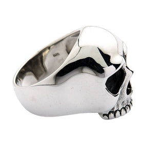 Side view of the skull ring with its smooth band interior and tapered shoulder visible.