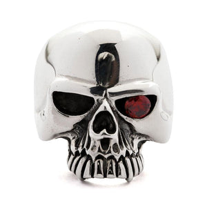 Sterling silver skull ring with a garnet eye — three quarter view
