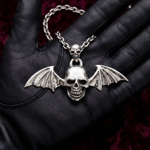 Sterling silver bat-wing vampire skull pendant displayed on a black leather glove