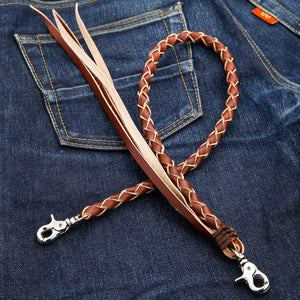 Tan Braided Leather Wallet Chain with Tassels, extended on denim