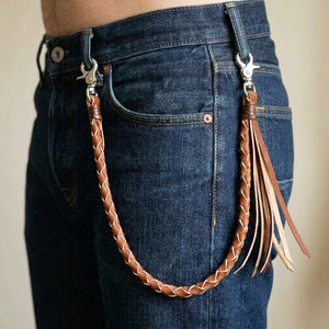 Tan Braided Leather Wallet Chain with Tassels, styled between denim belt loops