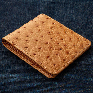 Tan Full-Quill Ostrich Leather Bifold Wallet showing tan ostrich quill texture across the front at an angle.