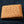 Tan Full-Quill Ostrich Leather Bifold Wallet showing the tan full-quill front and matching stitched edge.