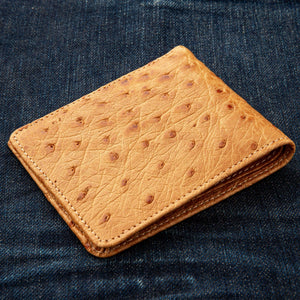 Tan Full-Quill Ostrich Leather Bifold Wallet showing the opposite tan quill panel viewed diagonally.