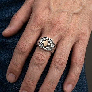 Gold Celtic Cross Sterling Silver Ring, worn on one middle finger in a natural hand close-up