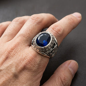 Tiger & Dragon Sterling Silver Ring with sapphire-blue CZ worn on an adult hand