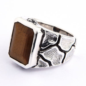 Tiger's Eye Ring with Textured Sterling Silver Band. The rectangular stone is angled to show its golden bands and beveled outline.