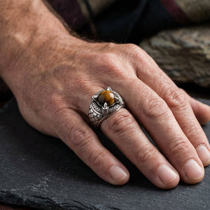 Tiger's eye claw silver ring worn on a hand