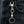 Clear-Eye Tribal Skull Sterling Silver Keychain, hanging from a denim belt loop