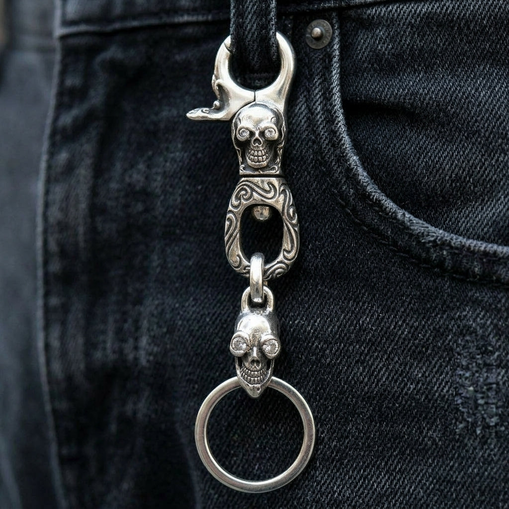 Clear-Eye Tribal Skull Sterling Silver Keychain, hanging from a denim belt loop