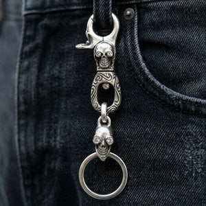 Clear-Eye Tribal Skull Sterling Silver Keychain, hanging from a denim belt loop