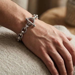 Tribal vine toggle silver bracelet worn on a wrist