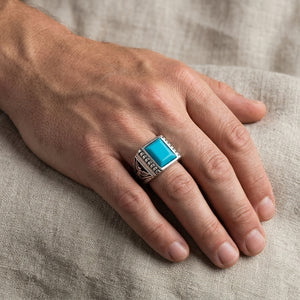 Turquoise eagle silver signet ring worn on a hand
