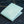 Turquoise Stingray Leather Bifold Wallet — closed denim angle