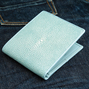 Turquoise Stingray Leather Bifold Wallet — closed denim angle