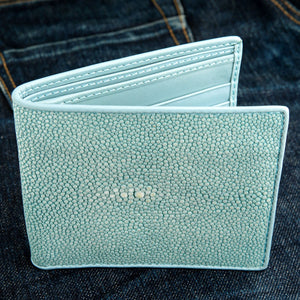 Turquoise Stingray Leather Bifold Wallet — open on denim front