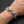 Twin bulldog sterling silver bracelet worn on a wrist, showing the sculpted heads and broad curb links.