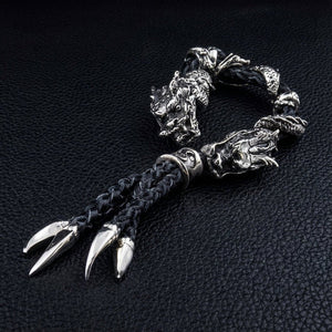 Twin Dragon Sterling Silver Leather Bracelet, angled dragon heads with braided leather and claw tassels