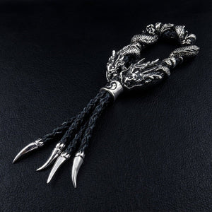 Twin Dragon Sterling Silver Leather Bracelet, side view of dragon heads and leather tassels