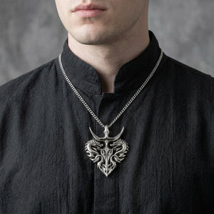 Twin-dragon silver pendant worn over a charcoal shirt; chain shown for styling