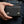 Twin-Flame Concho Black Leather Trifold Wallet, held at hip level
