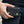 Twin-Flame Concho Black Leather Trifold Wallet, held at hip level