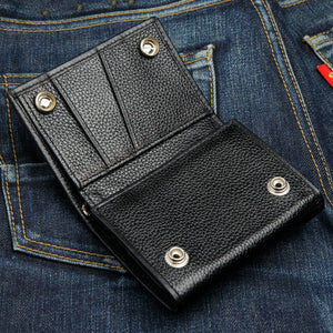 Twin-Flame Concho Black Leather Trifold Wallet, open wallet denim view