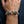 Twin lion head sterling silver bracelet worn on a wrist, with carved manes and cross-marked links.