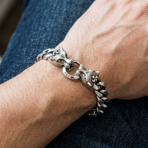 Twin Wolf Head Sterling Silver Curb Bracelet worn on an adult wrist, showing twin wolf heads and curb links.