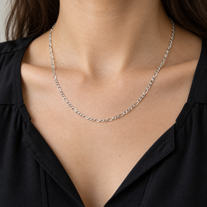 2mm Figaro Sterling Silver Link Necklace showing short and long links around a black blouse neckline.