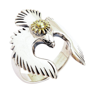 A shot of the two-tone bird ring, focusing on the intricate golden sun symbol on the bird's back.