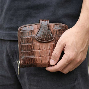 Two-Tone Brown Crocodile Tail Snap Wallet held beside the hip