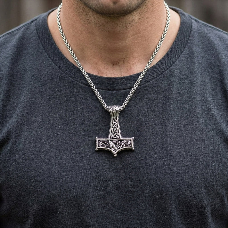 Viking knot silver Thor hammer pendant worn over a charcoal shirt