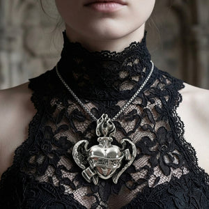 Winged heart sterling silver pendant shown larger on a gothic-styled model; chain shown for styling