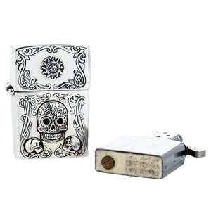 Mexican sugar skull sterling silver lighter case beside a separate standard Zippo insert; insert not included