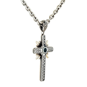Three-quarter view of the hanging silver gothic cross, showcasing the central blue eye, gold rays, and thick cable chain.