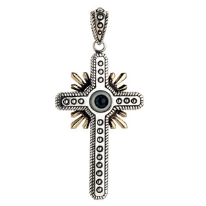 Front view of a sterling silver gothic cross pendant featuring a blue evil eye center and gold-toned sunburst rays.